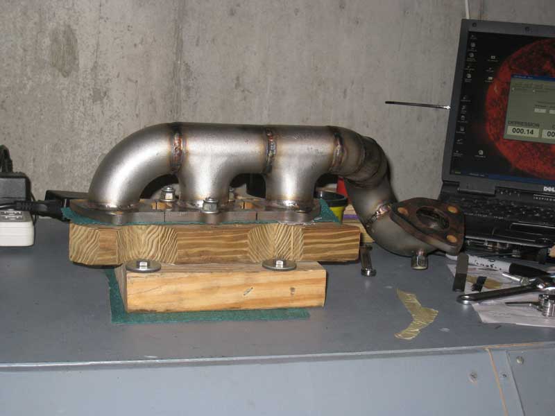 silly rabbit motorsport exhaust manifold mounted on flowbench